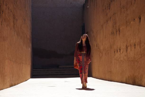 istock Contemplative and content lady in a brightly lit alley 1079953844