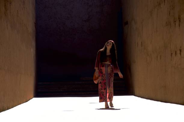 istock Lady striding down a brightly lit alleyway 1079954678