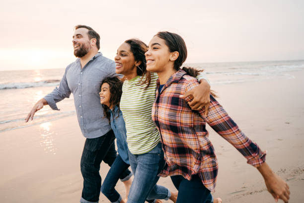 istock Sunset at the beach with family 1079962636