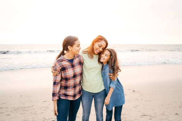 istock Mother with two daughters on the beach 1079962718