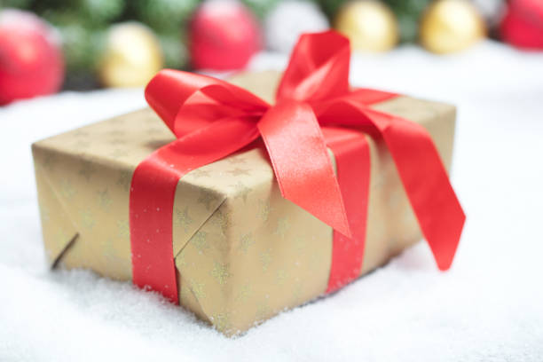 istock christmas gift box on snow 1079971100