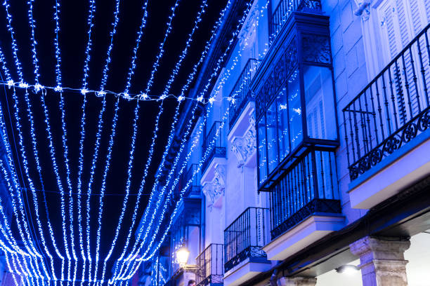 istock Illuminated street with blue Christmas illumination, which is reflected in a balcony that has crystals. 1080007510