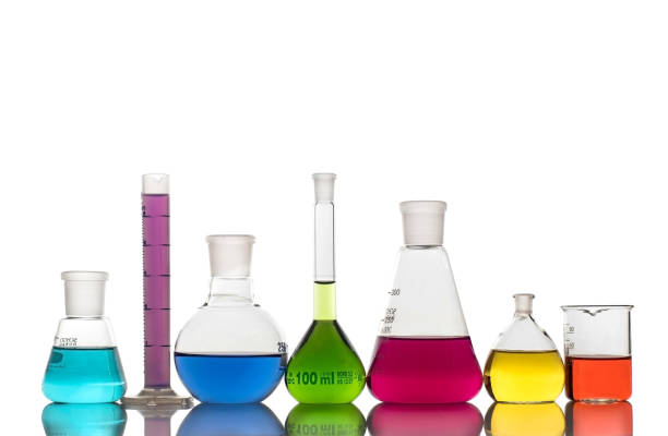 laboratory glassware with colorful liquids on white background - laboratory glassware beaker flask glass imagens e fotografias de stock