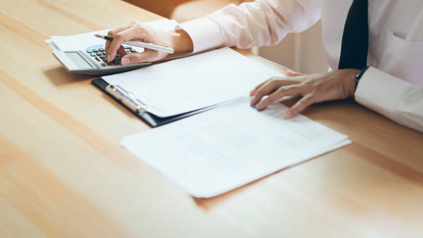istock Businessman working at his office with documents and check the accuracy of information. 1080019500