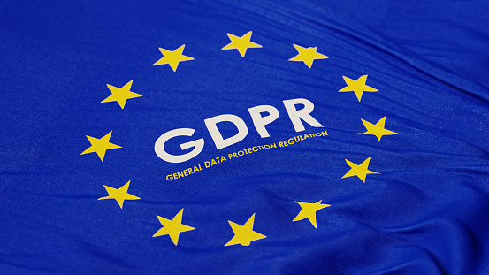 European Union flag with GDPR text in the middle. Horizontal composition with copy space. High angle view.
