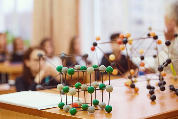 istock Students sit in the classroom and listen to a lecture in science. Plastic molecular educational model. Soft focus background image 1080044202