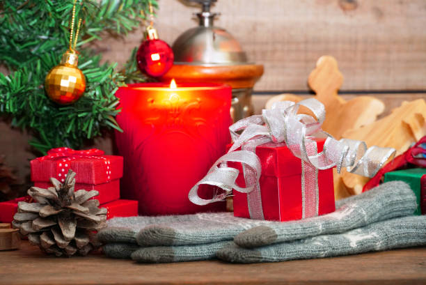 istock Red gift boxes lay on gloves with candle decorate under christmas tree 1080073292
