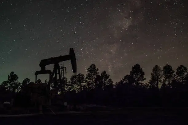 Astrophoto of a pump jack in East Texas with the Milky Way behind