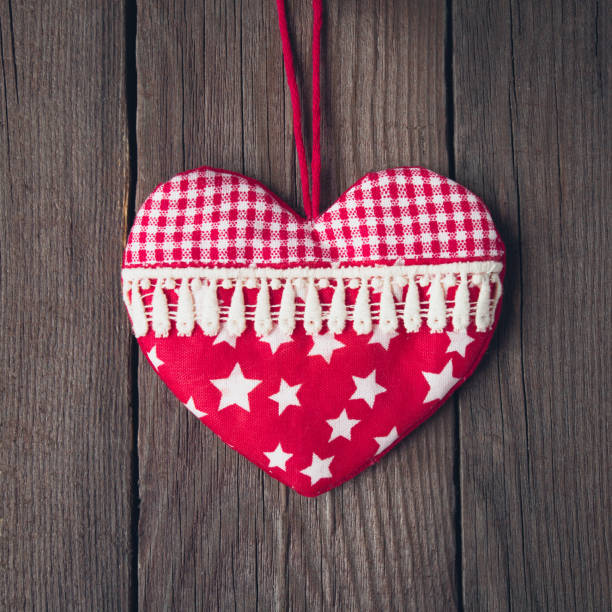 istock Old toy heart on a wooden background 1080083140