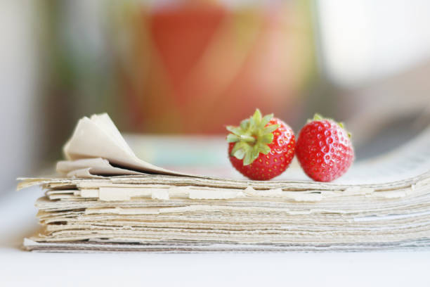 Newspapers and strawberry stock photo