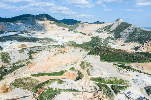 Landfill,Sand mountains, concrete, lots of cranes.\nViewpoint from directly above.