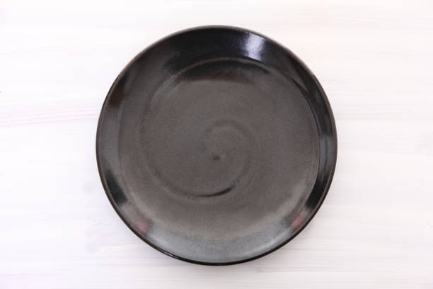 istock empty black dish on the white wooden table 1080093606