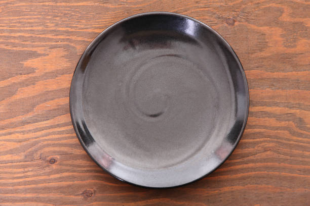 istock empty black dish on the wooden table 1080093710