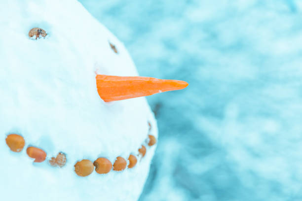 istock snowman with santa hat close up 1080095180