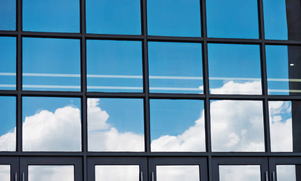 istock Blue sky reflected on wall of modern office building 1080095776