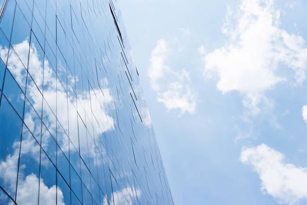 istock Blue sky reflected on wall of modern office building 1080095838