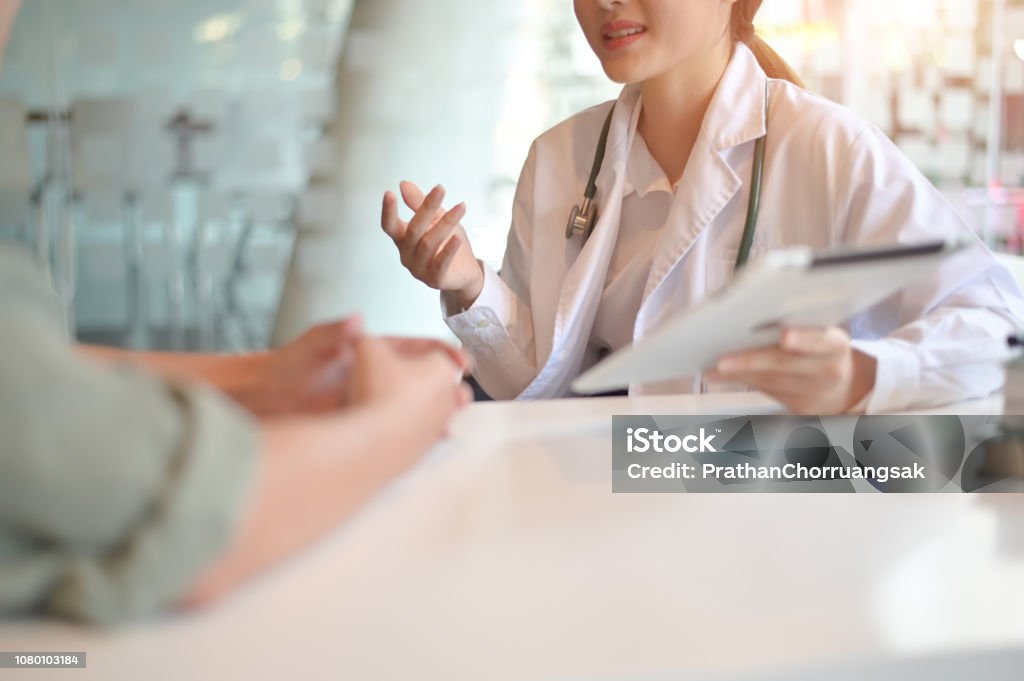 Doctor woman consulting patient sitting at doctor office. prevention of men diseases, healthcare, medical service, consultation, concept. Patient Stock Photo