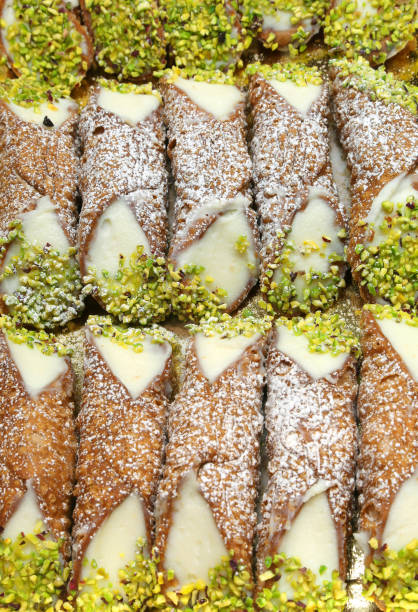 delicious Sicilian cannoli with grated pistachios Background of Sicilian cannoli with grated pistachios and cream cannoli photos stock pictures, royalty-free photos & images