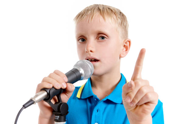 istock Little blond boy talking confidently into microphone 1080110356