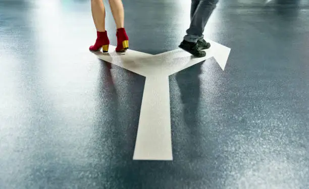 Man and woman walking on different directions.