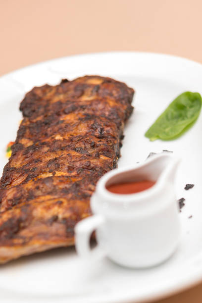 istock Grilled rib pork with barbecue sauce, placed on white plate, light background 1080112740