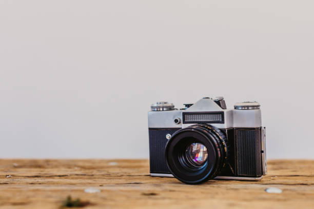 istock Vintage camera on brown wooden table, with text space 1080115180
