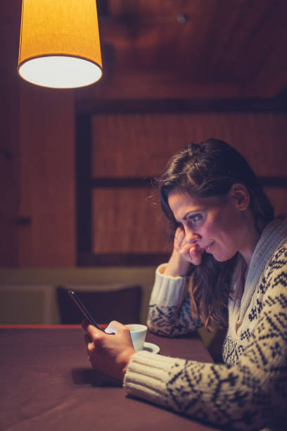 istock Young women enjoy coffee break. She using mobile phone at cafe. 1080115990