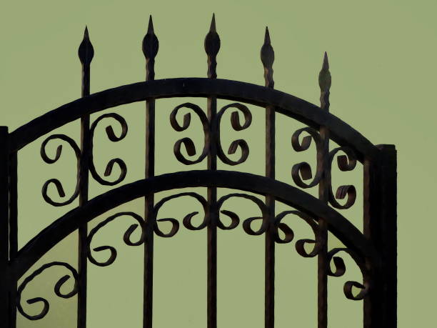 istock Iron fence details with green wall background 1080120702