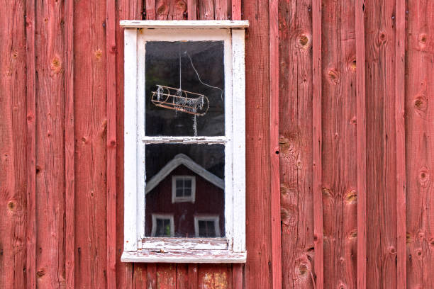 a little window in front of a typival scandinavian building with falu red - falun imagens e fotografias de stock