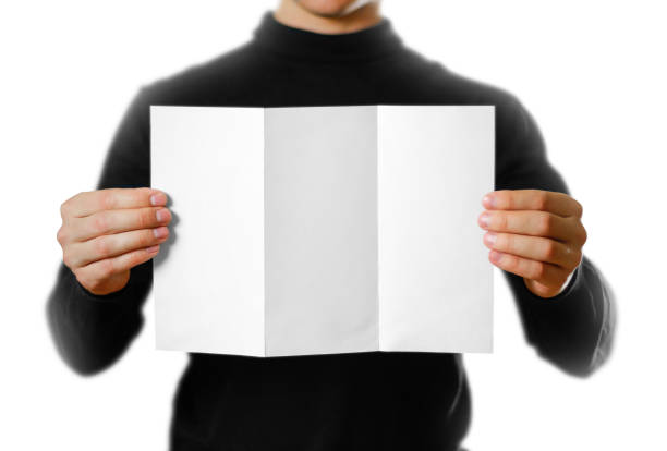 istock Man showing blank white flyer brochure booklet. Leaflet presentation. Pamphlet hold hands. Man show clear offset paper 1080132350