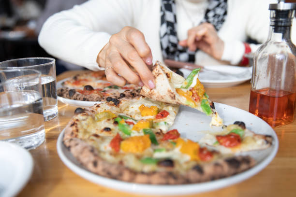 istock Senior woman eating pizza 1080135460
