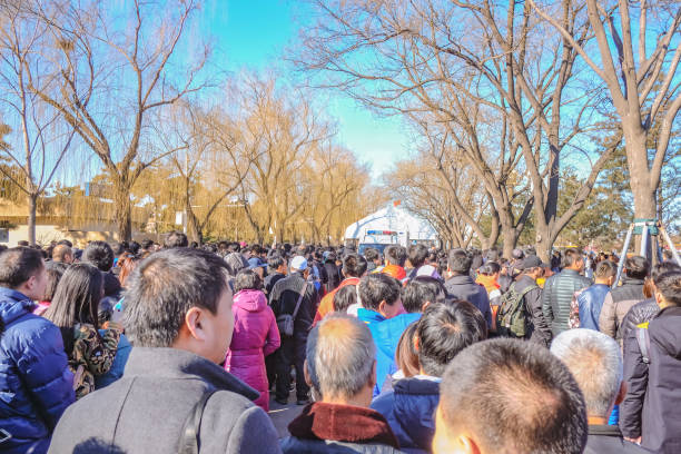 a lot of unacquainted chinese people or tourist waiting for entry to tiananmen square - tiananmen square imagens e fotografias de stock