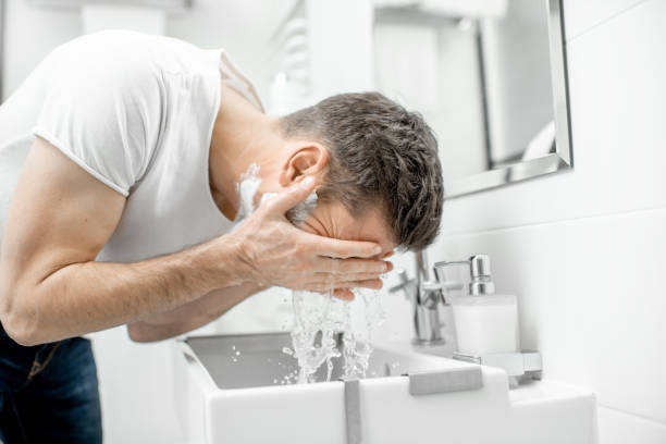 Man washing face in the bathroom
