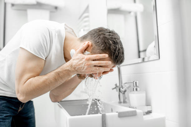 istock Man washing face in the bathroom 1080139738
