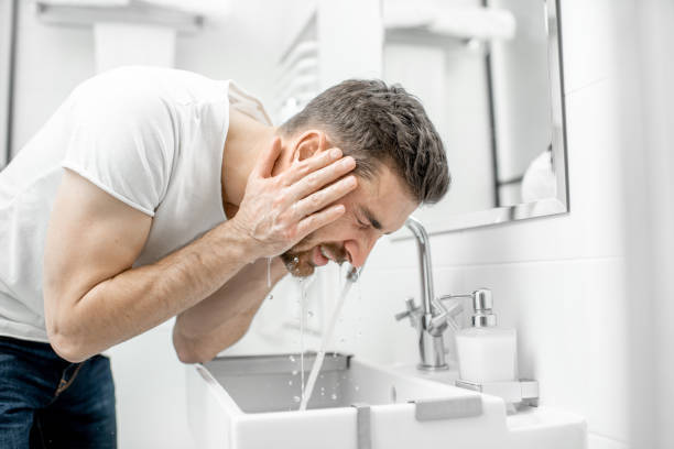istock Man washing face in the bathroom 1080139760