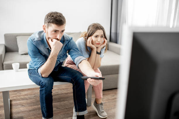 istock Young couple watching TV at home 1080140556