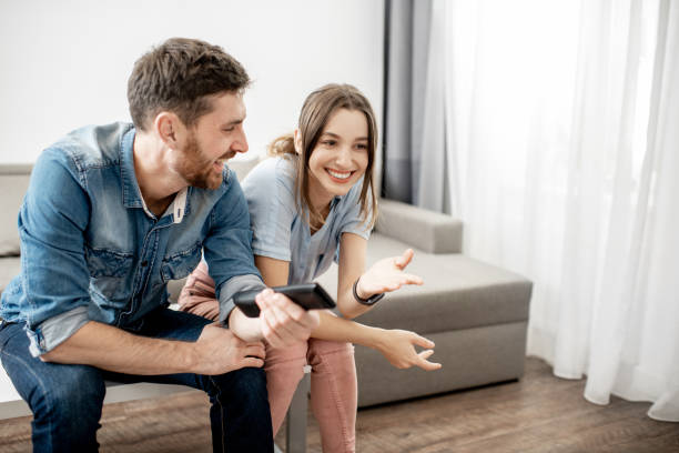 istock Young couple watching TV at home 1080140582