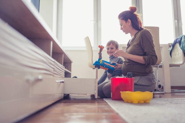 istock Pregnant mother and son playing at home 1080146692