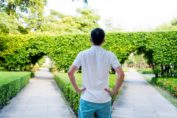 istock Man standing in front of forked road 1080147072