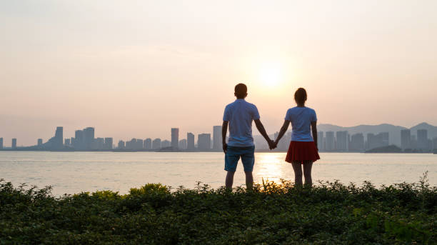 istock Couple holding hands on the beach at sunset 1080148680