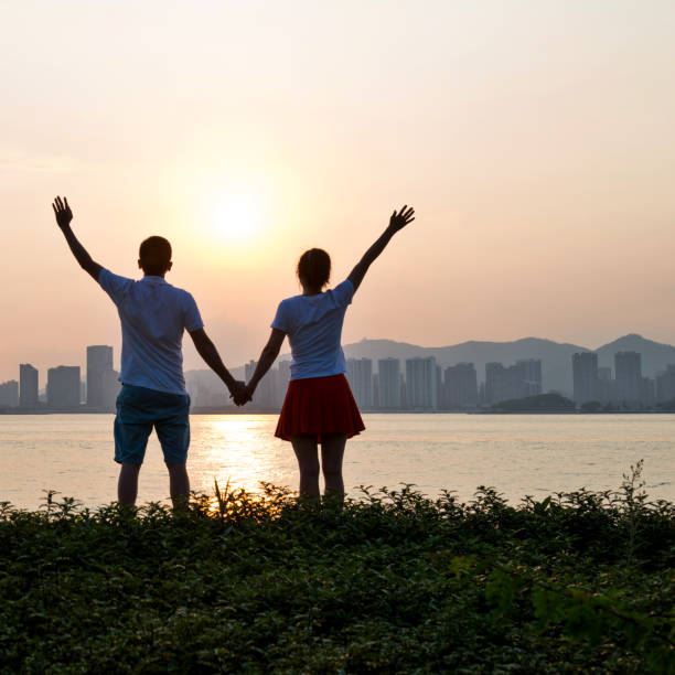istock Couple holding hands on the beach at sunset 1080148866