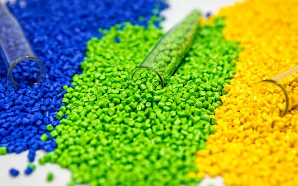 Photo of Plastic granules. Polymer pellets. Polymeric dye. Colorant pellets.