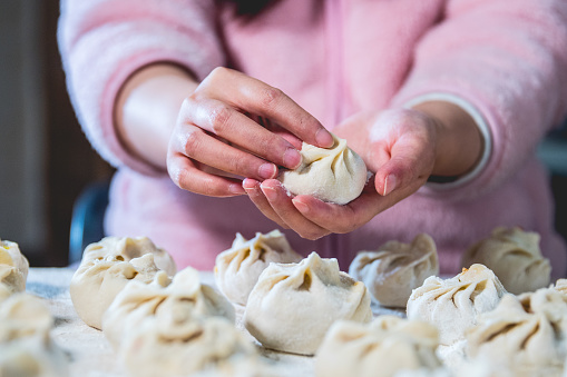 Woman wrapping Chinese bun(baozi)