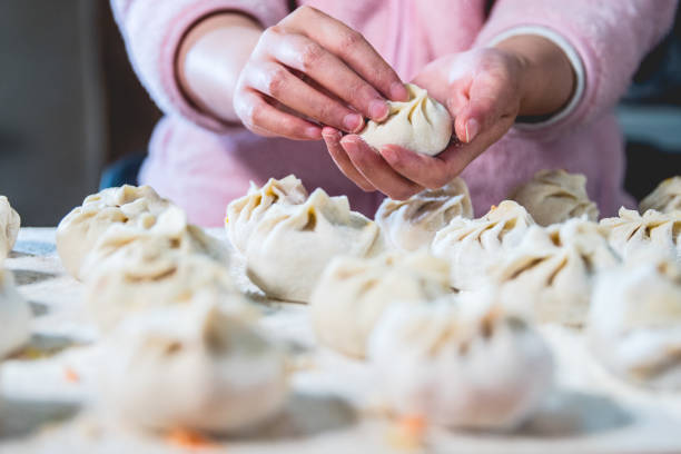 Woman wrapping Chinese bun(baozi)