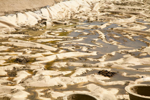 istock Dirty liner at a bottom of a drained pond 1080154426