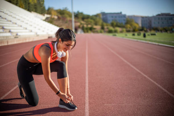istock Woman tying shoelaces before training 1080158126