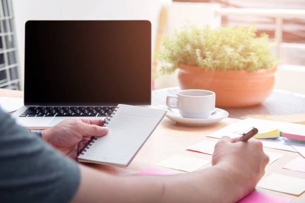 istock New. Business man holding pen meeting at home office and using notes paper share design planning ,brainstorming brainstorm idea on desktop 1080161546