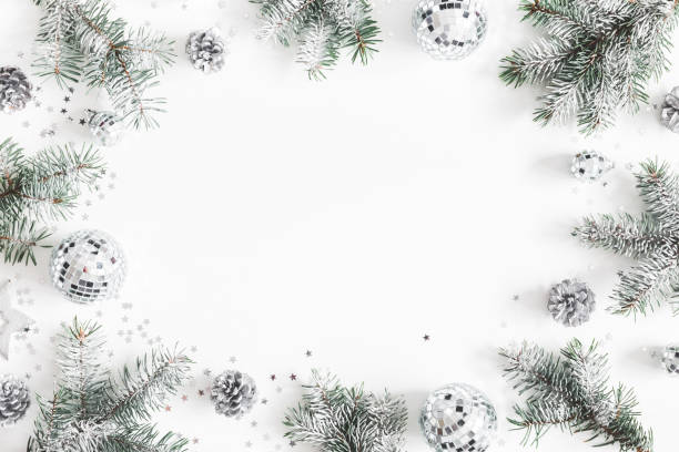 istock Christmas composition. Frame made of fir tree branches, silver decorations on white background. Christmas, winter, new year concept. Flat lay, top view, copy space 1080166630