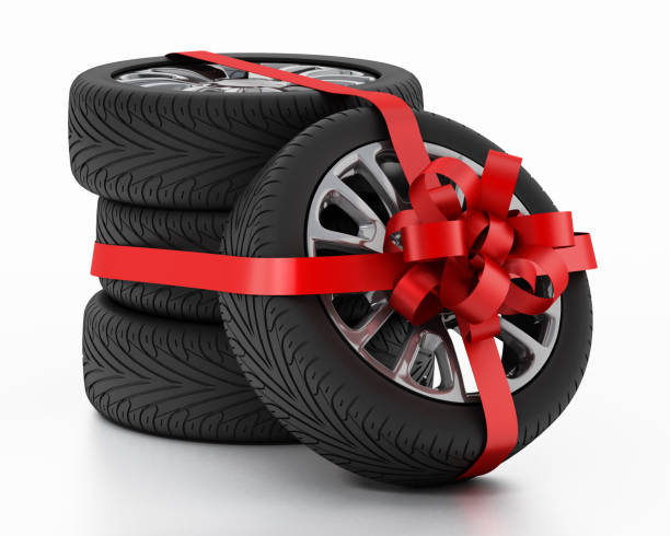 new tires wrapped with red ribbon - car tire red new imagens e fotografias de stock