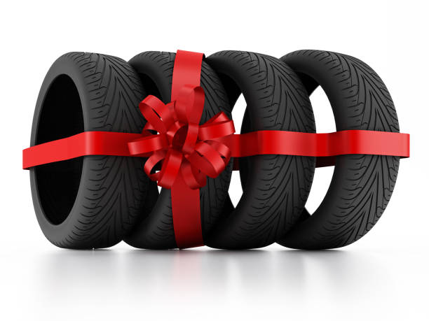 istock New tires wrapped with red ribbon 1080167736